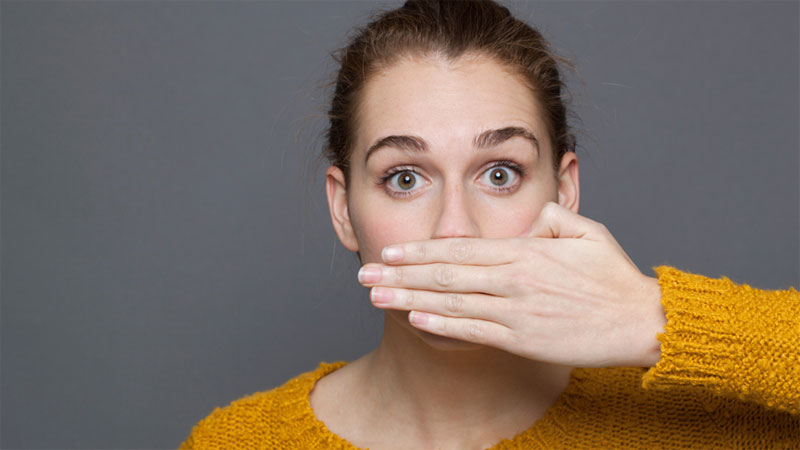 Woman Covering Mouth